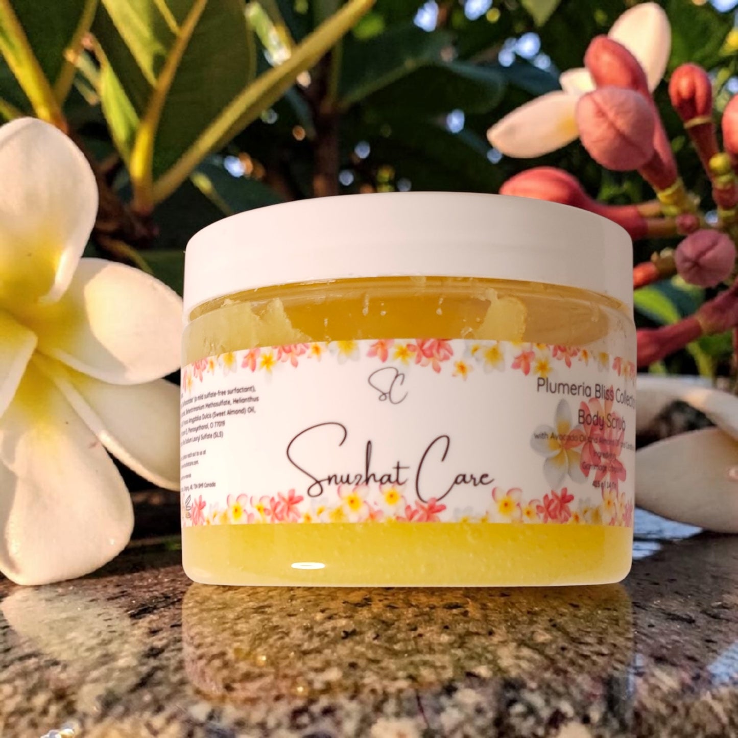 Luxury plumeria body and bath collection featuring body wash, body butter, scrub, bath salts, bath bombs and handmade soap for tropical spa self-care by Snuzhat Care