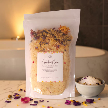 Luxury plumeria body and bath collection featuring body wash, body butter, scrub, bath salts, bath bombs and handmade soap for tropical spa self-care by Snuzhat Care