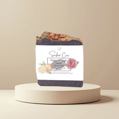 Handmade rosy orange charcoal soap bar with activated charcoal, rose petals, shea butter and citrus oils for refreshing botanical skincare by Snuzhat Care