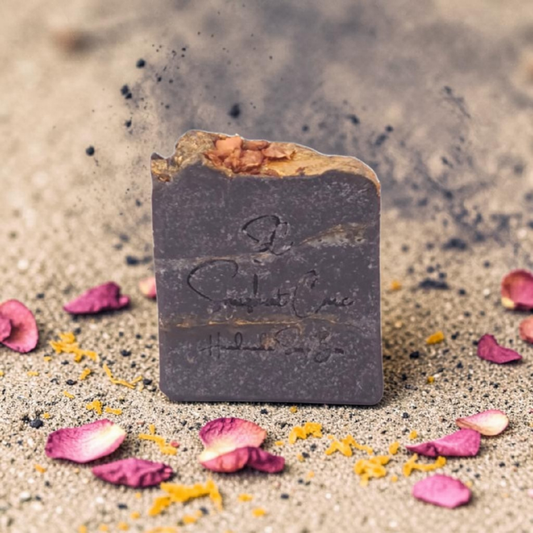 Handmade rosy orange charcoal soap bar with activated charcoal, rose petals, shea butter and citrus oils for refreshing botanical skincare by Snuzhat Care