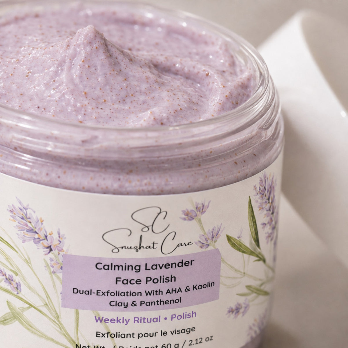 Close-up of Calming Lavender Face Polish creamy exfoliating texture and product label